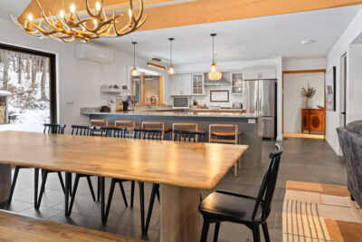 Dining area overlooking the valley with rustic-modern Vermont interior design