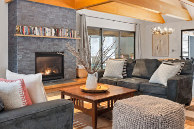 Spacious Vermont living room with fireplace and vaulted ceilings at All Seasons