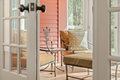 Charming screened porch overlooking Vermont’s natural beauty—ideal for seasonal entertaining.
