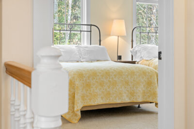 Generous primary bedroom with en-suite bath and large windows providing natural light.